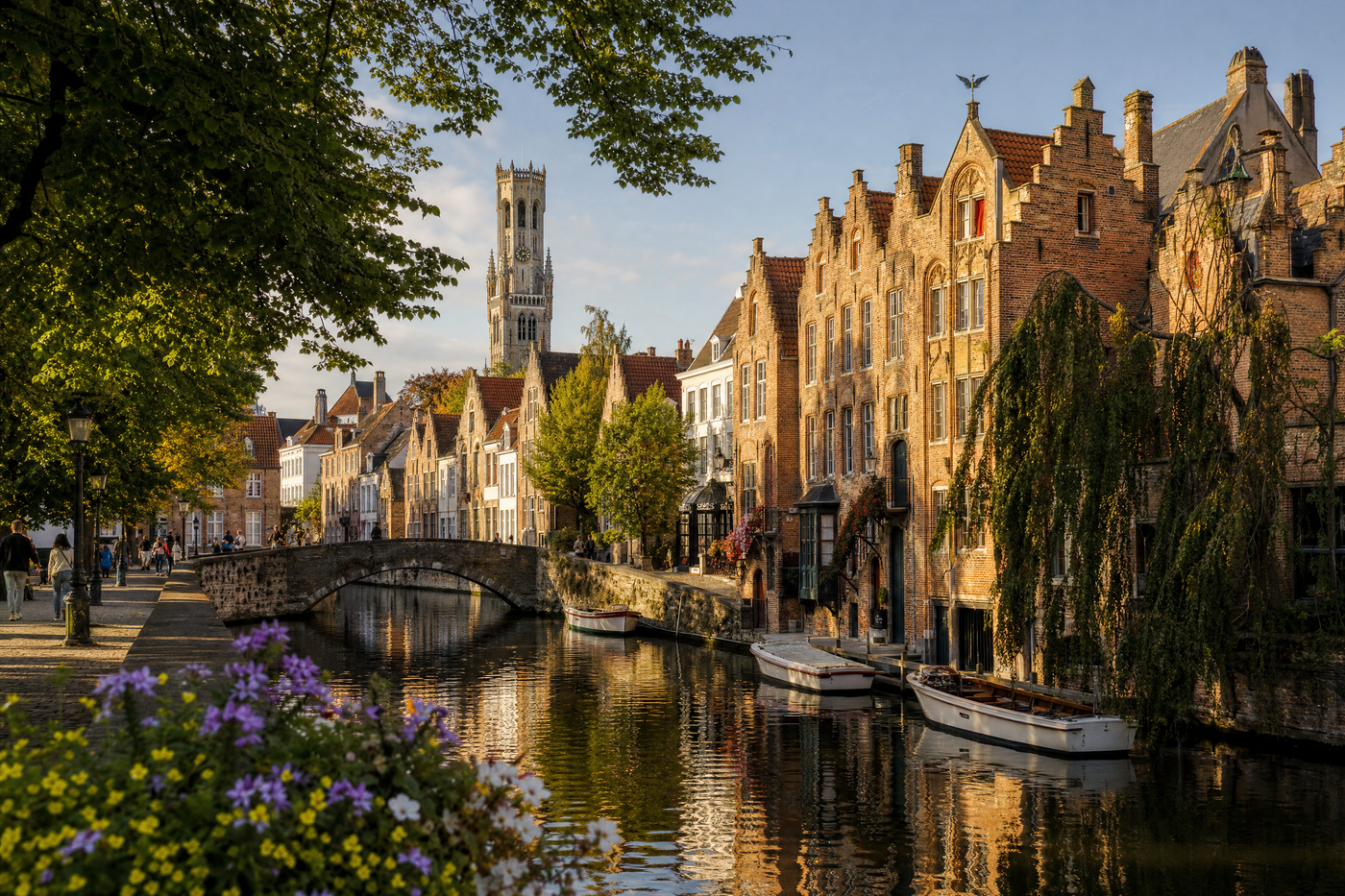 View of Bruges city center with canals and historic buildings in bloom under spring sunshine