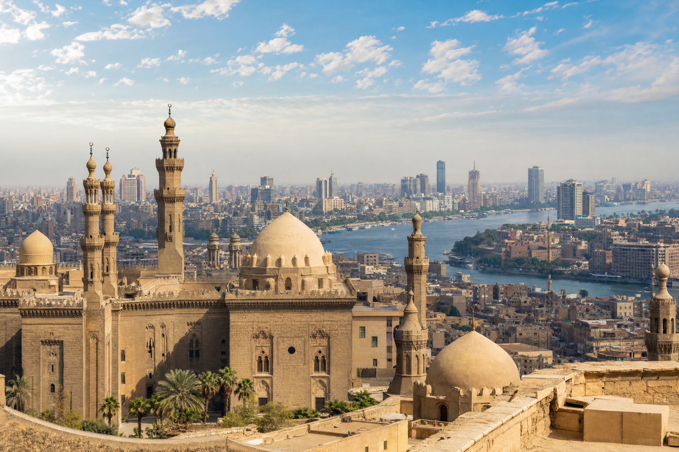 The sun rises over Cairo, illuminating the Pyramids and cityscape.