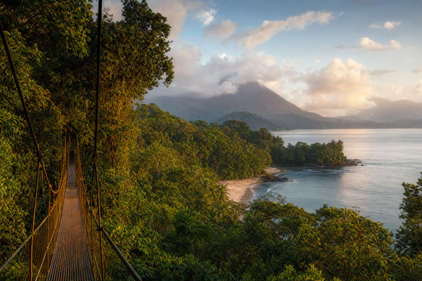Sunset over a lush Costa Rican beach with light crowds and bright weather