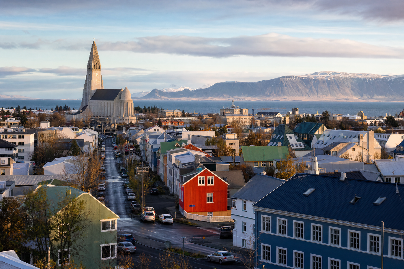 Panoramic view of Reykjavik with colorful rooftops under varying seasonal skies