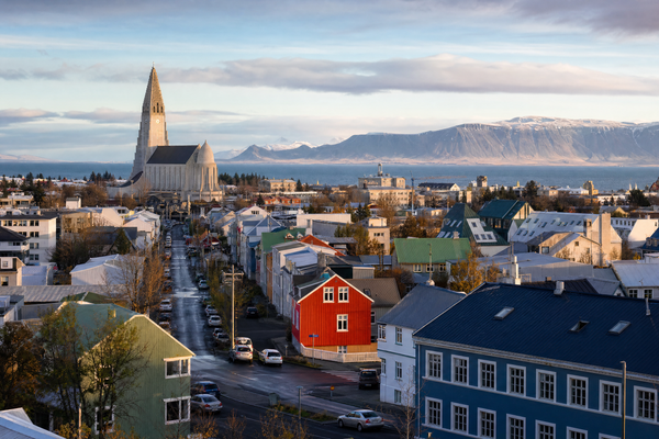 Panoramic view of Reykjavik with colorful rooftops under varying seasonal skies