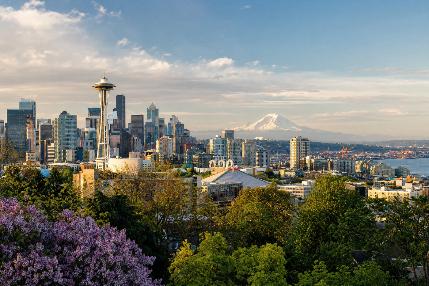 Seattle skyline and Mount Rainier during a clear day with blue sky, ideal travel weather.