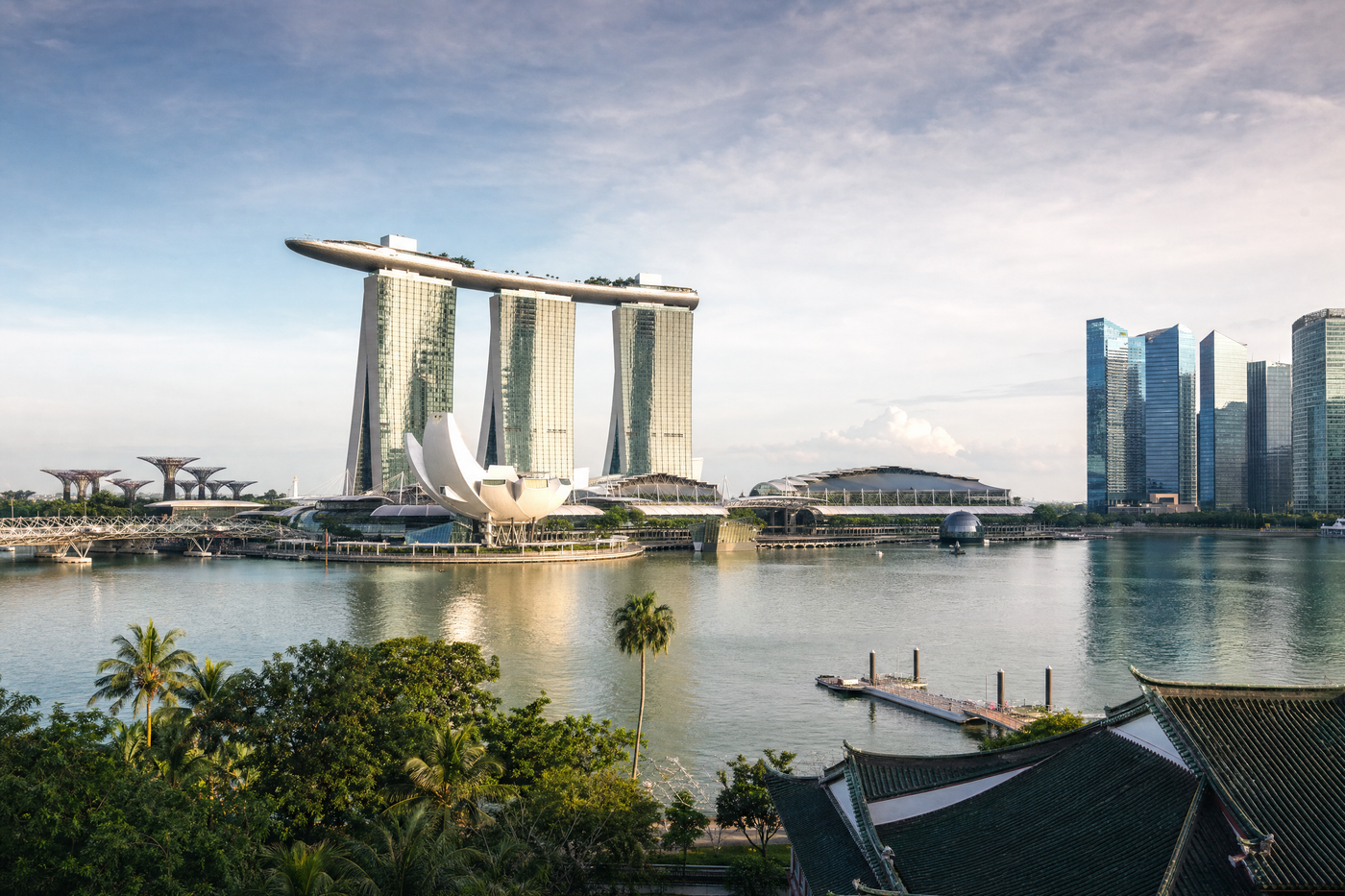 Marina Bay skyline and lush gardens under a blue sky in Singapore