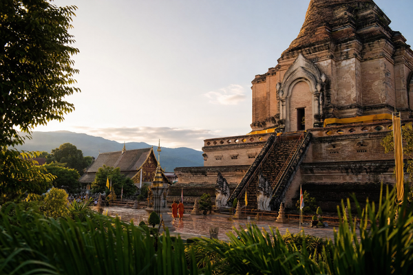 Dawn light over Chiang Mai Old City skyline with temples and mountains in background