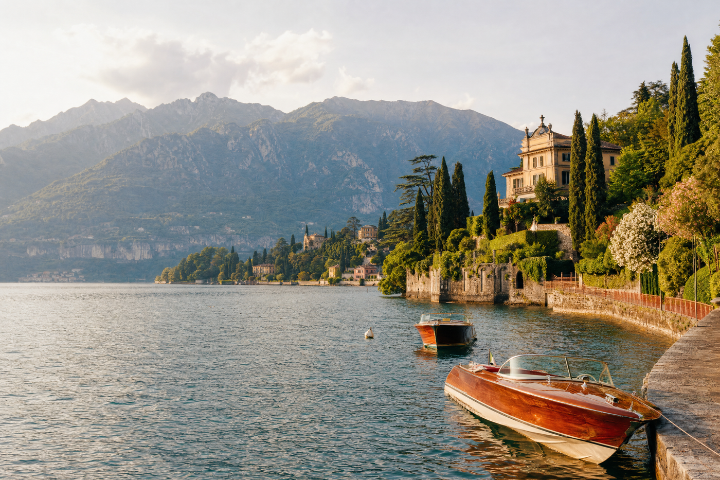 Budget travelers admiring Lake Como from a scenic lakeside path