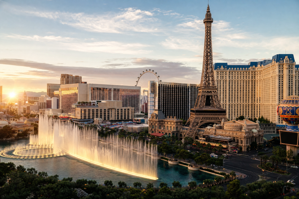 A panoramic view of the Las Vegas Strip at night, lit with colorful neon lights
