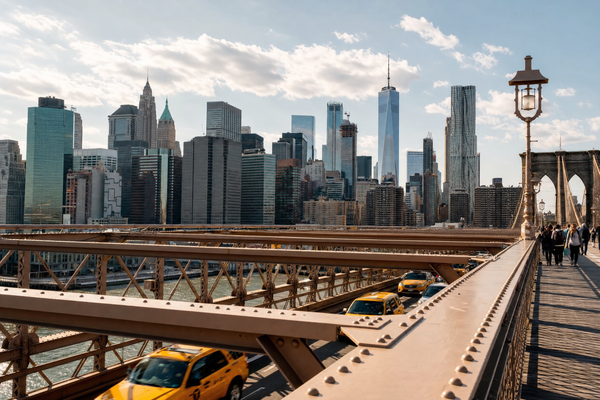 A panoramic view of New York City's skyline at sunset, with iconic landmarks visible