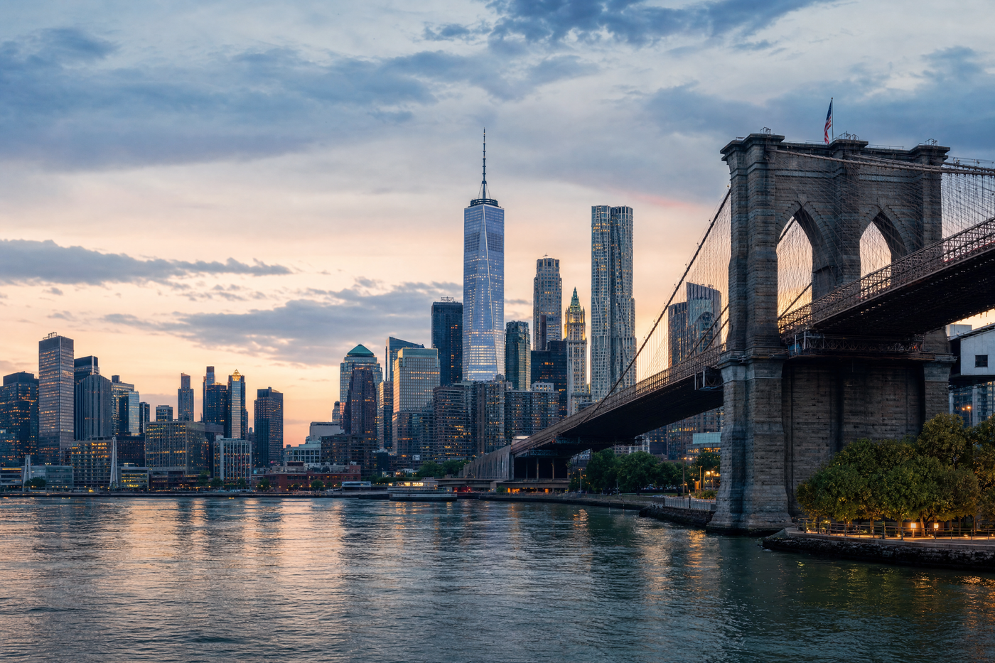 New York City skyline at sunset with famous landmarks including Empire State Building and Central Park
