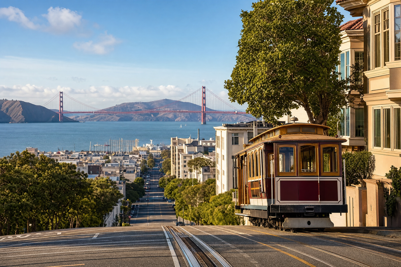 A classic San Francisco cable car climbs a hill with the city skyline and bay in the background.