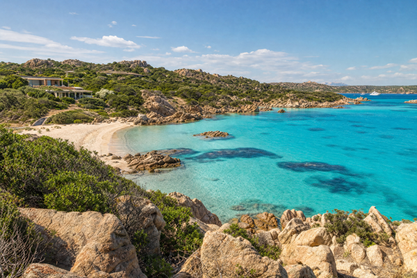 Panoramic view of Sardinia coastline with turquoise sea and historic town