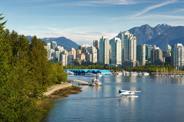 The Vancouver skyline with mountains in the background and boats in the harbor