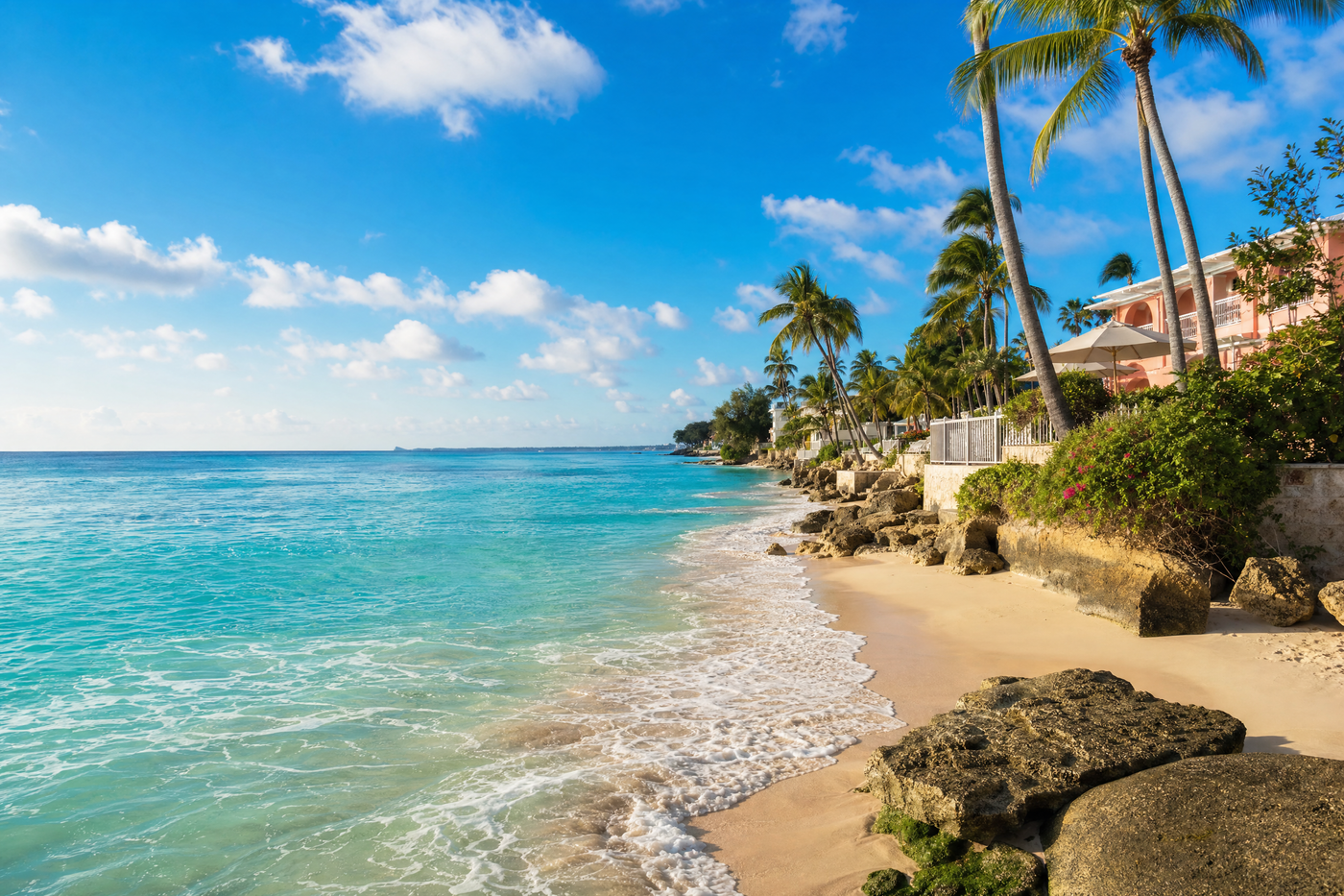 View of a Barbados beach with local neighborhoods behind