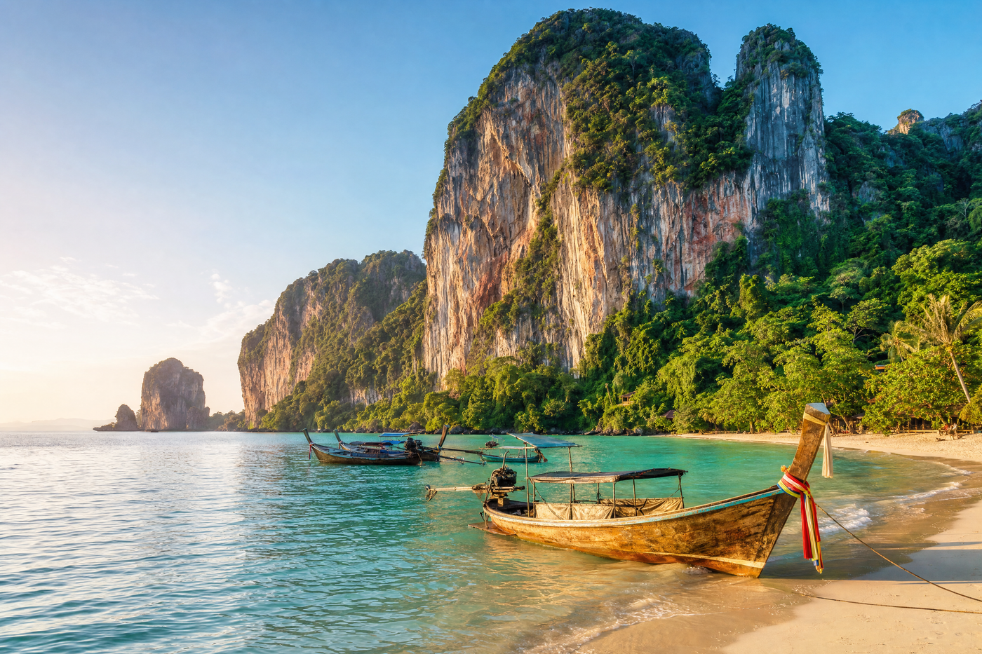 A scenic view of the Krabi coastline with hotels, limestone cliffs, and turquoise water