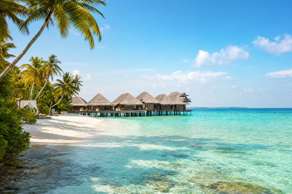 Maldives island resort with turquoise water and overwater villas