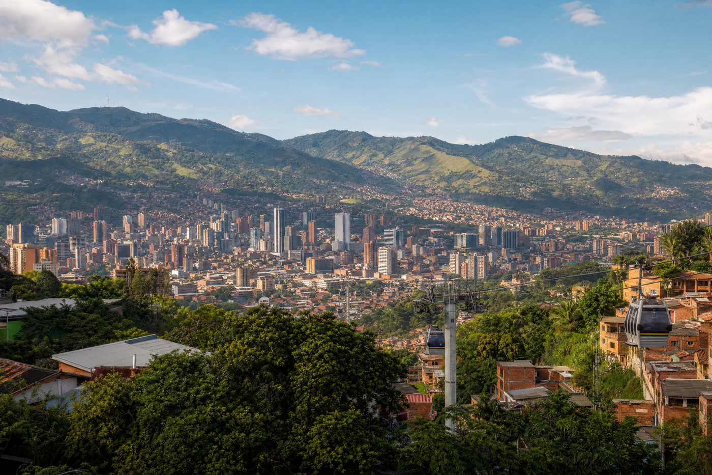 Aerial view of Medellin’s neighborhoods with city life and mountains
