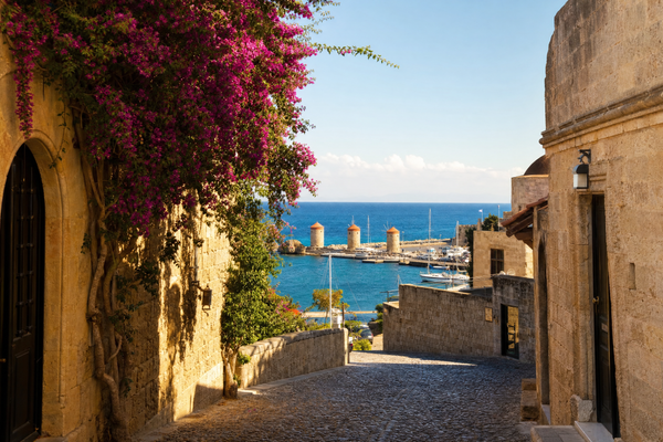 A panoramic view of Rhodes town, medieval walls, and turquoise coastline