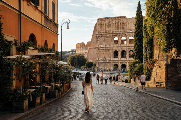 Rooftop view of Rome with St. Peter's Basilica and colorful neighborhoods at sunset